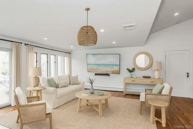 a large white kitchen with wooden floors and white cabinets