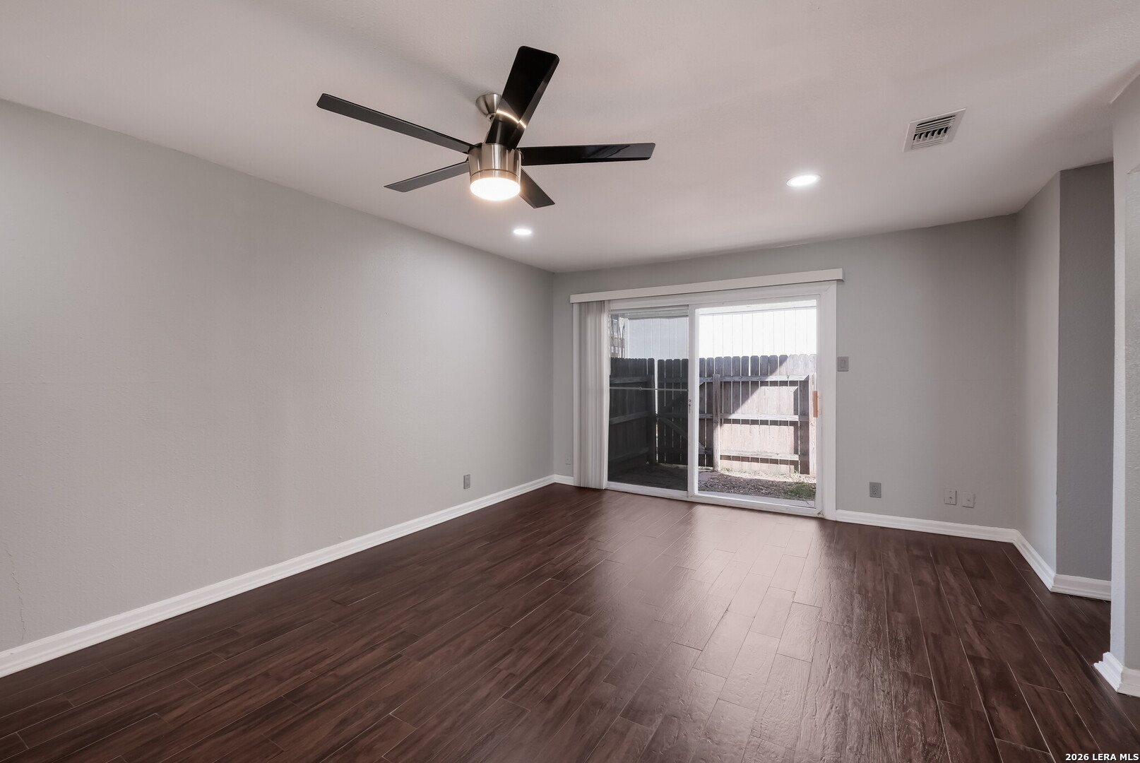100 Lorenz Road, Unit 804 San Antonio, TX 78209 - Photo 5 of 12 a view of an empty room with wooden floor and a ceiling fan