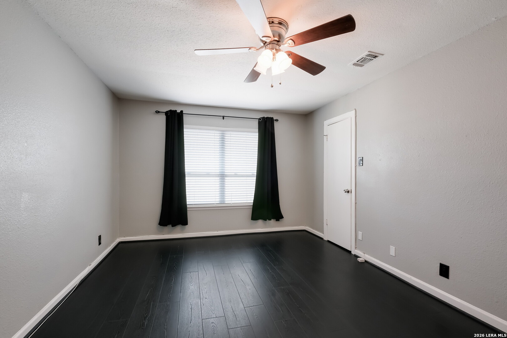 100 Lorenz Road, Unit 804 San Antonio, TX 78209 - Photo 7 of 12 an empty room with wooden floor and windows