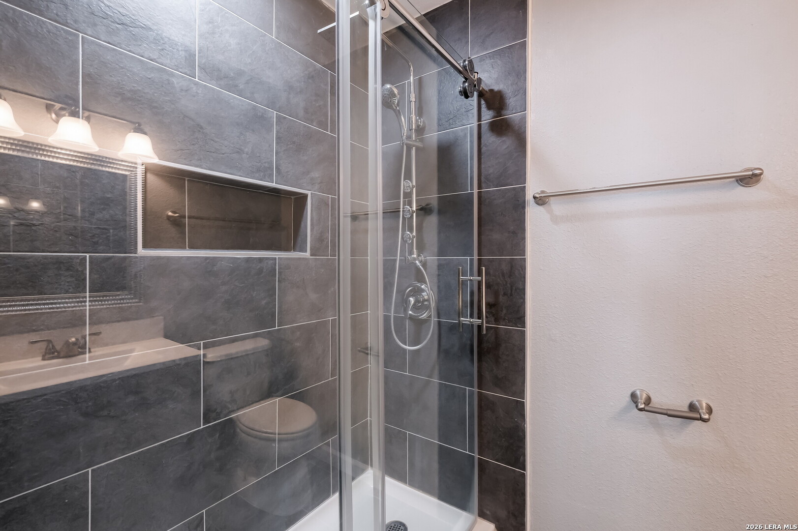100 Lorenz Road, Unit 804 San Antonio, TX 78209 - Photo 8 of 12 a bathroom with a shower and a mirror