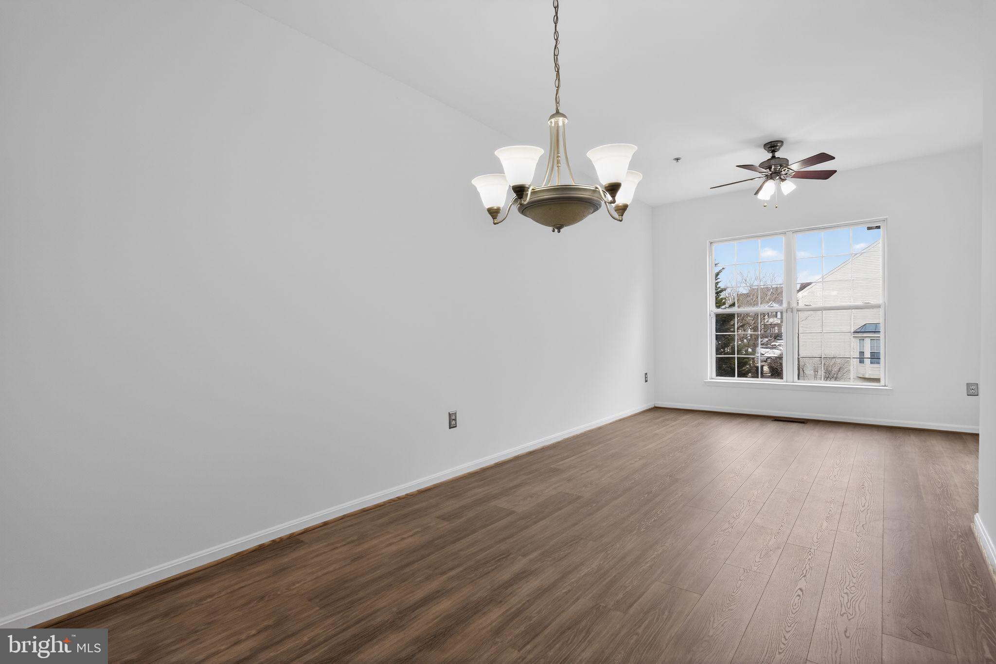 9745 Quiet Brook Lane Clinton, MD 20735 - Photo 11 of 43 a view of a room with wooden floor and ceiling fan
