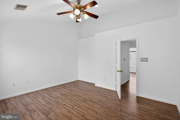 a view of an empty room with wooden floor