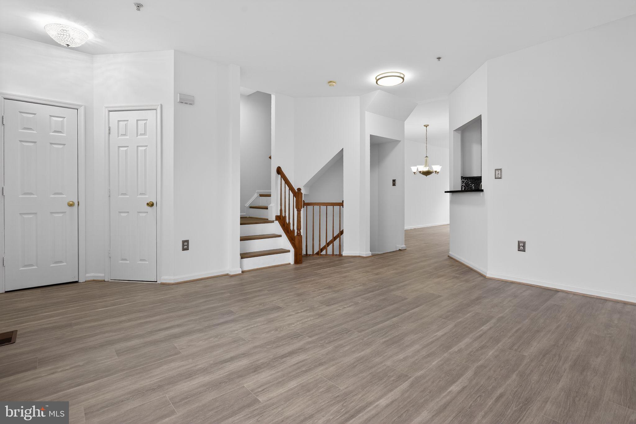 9745 Quiet Brook Lane Clinton, MD 20735 - Photo 16 of 43 a view of an empty room with wooden floor and a window