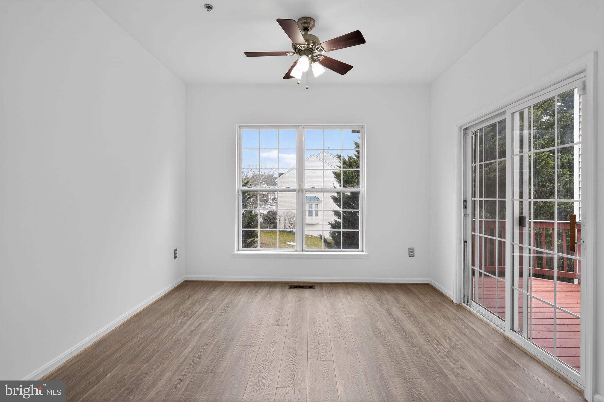 9745 Quiet Brook Lane Clinton, MD 20735 - Photo 18 of 43 an empty room with wooden floor and windows