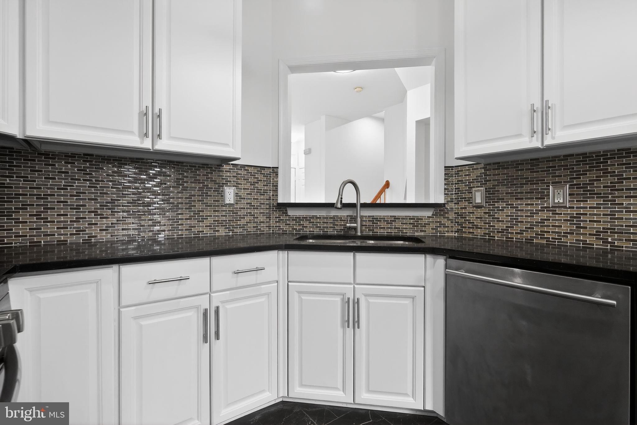 9745 Quiet Brook Lane Clinton, MD 20735 - Photo 25 of 43 a sink with white cabinets