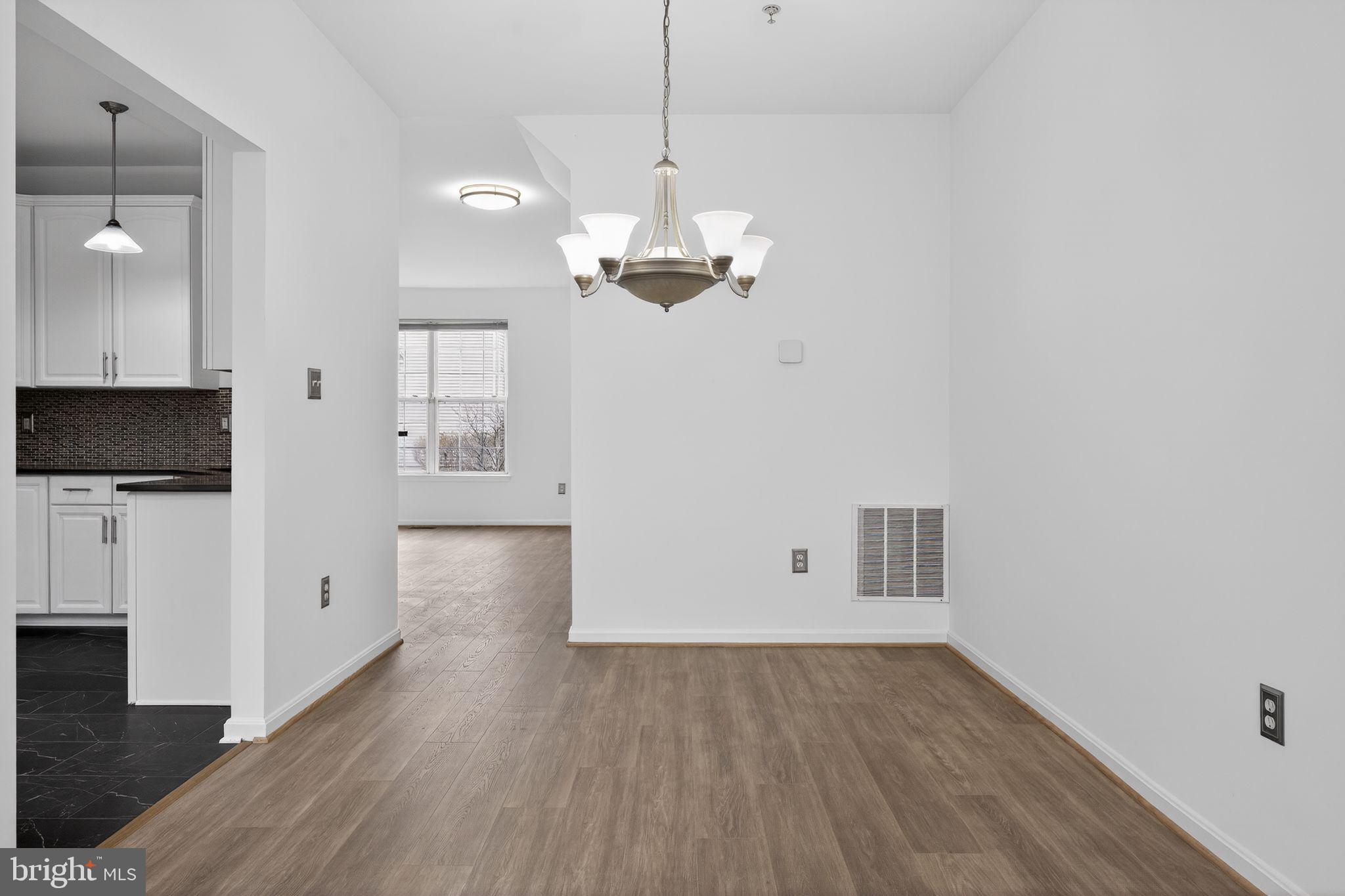 9745 Quiet Brook Lane Clinton, MD 20735 - Photo 27 of 43 a view of a room with wooden floor and a ceiling fan