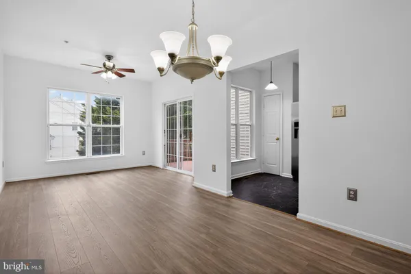 a view of a chandelier fan and wooden floor