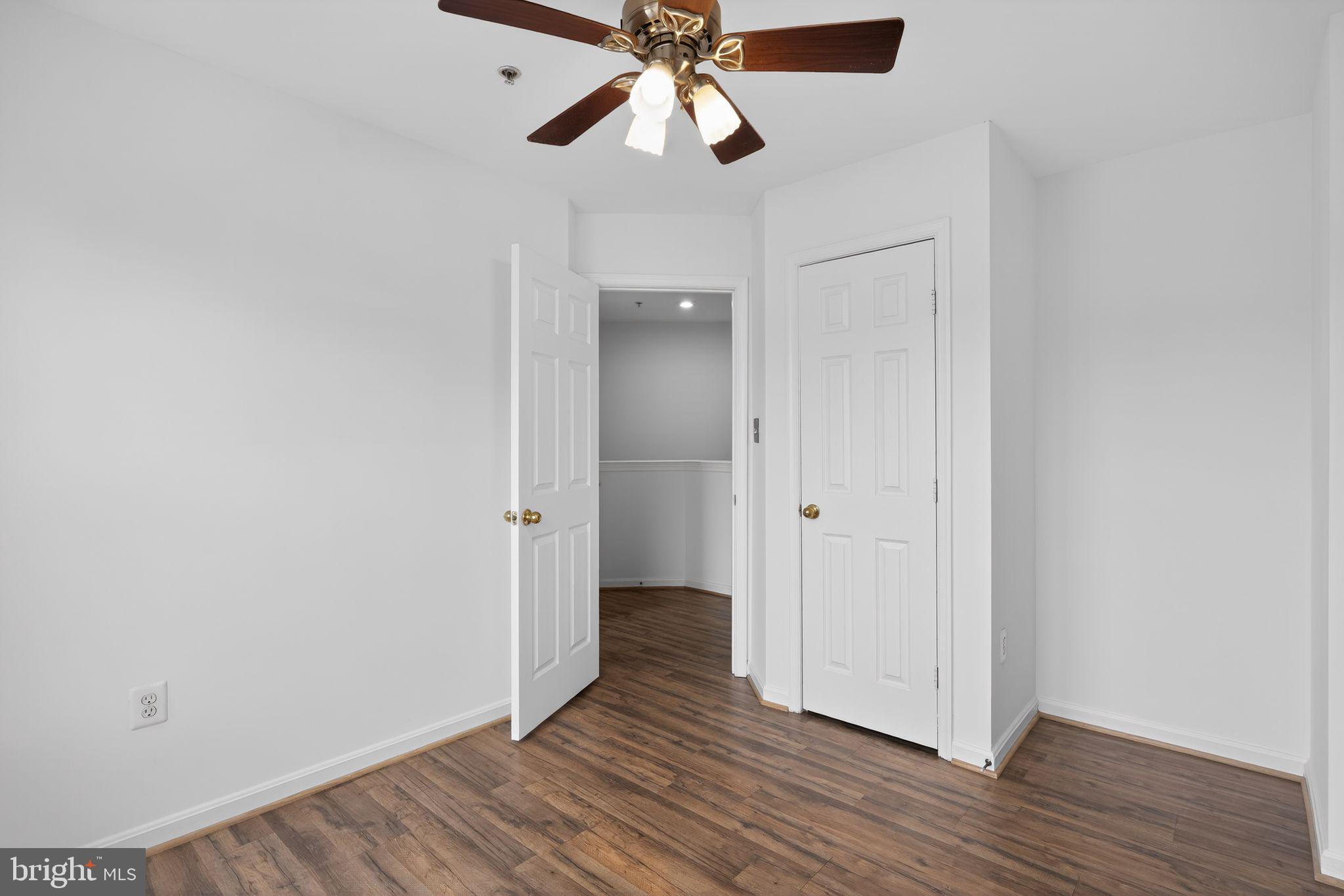 9745 Quiet Brook Lane Clinton, MD 20735 - Photo 29 of 43 a view of an empty room and wooden floor