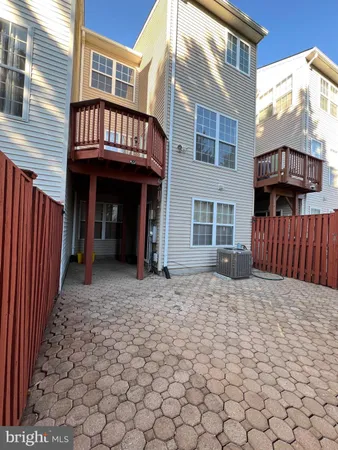 a view of a house with wooden fence