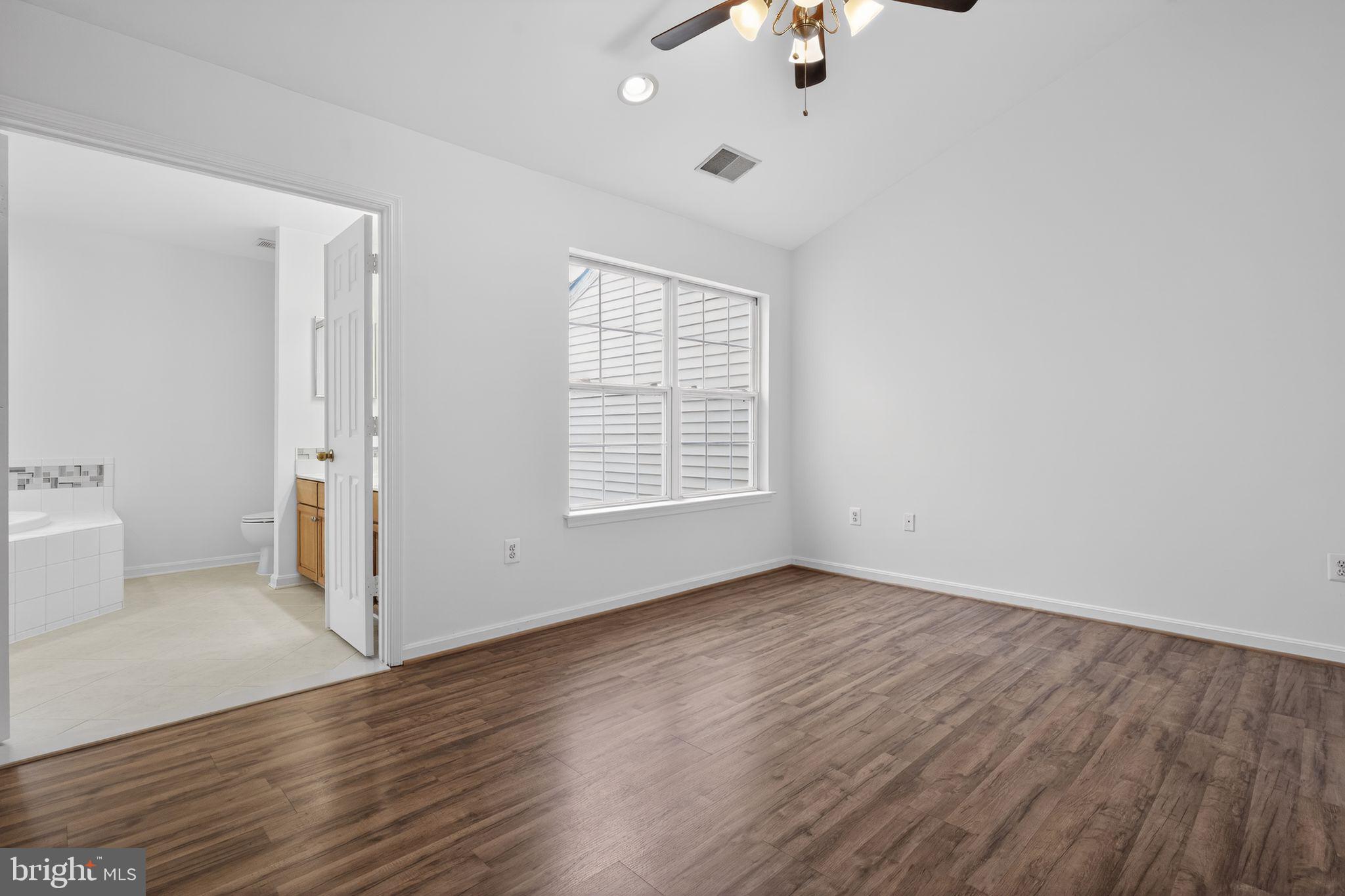 9745 Quiet Brook Lane Clinton, MD 20735 - Photo 32 of 43 wooden floor in an empty room with a window