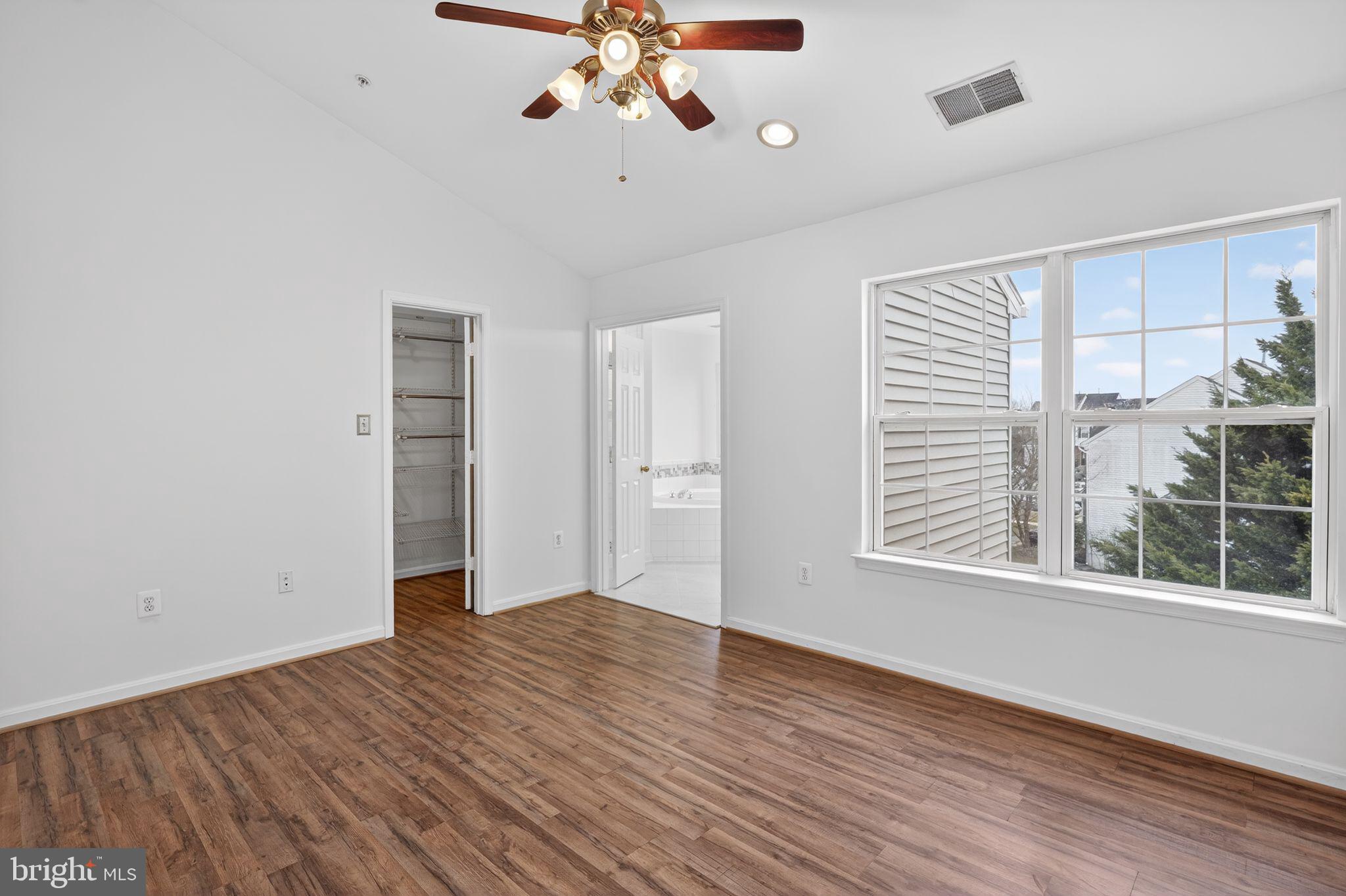 9745 Quiet Brook Lane Clinton, MD 20735 - Photo 33 of 43 a view of an empty room with a window and wooden floor