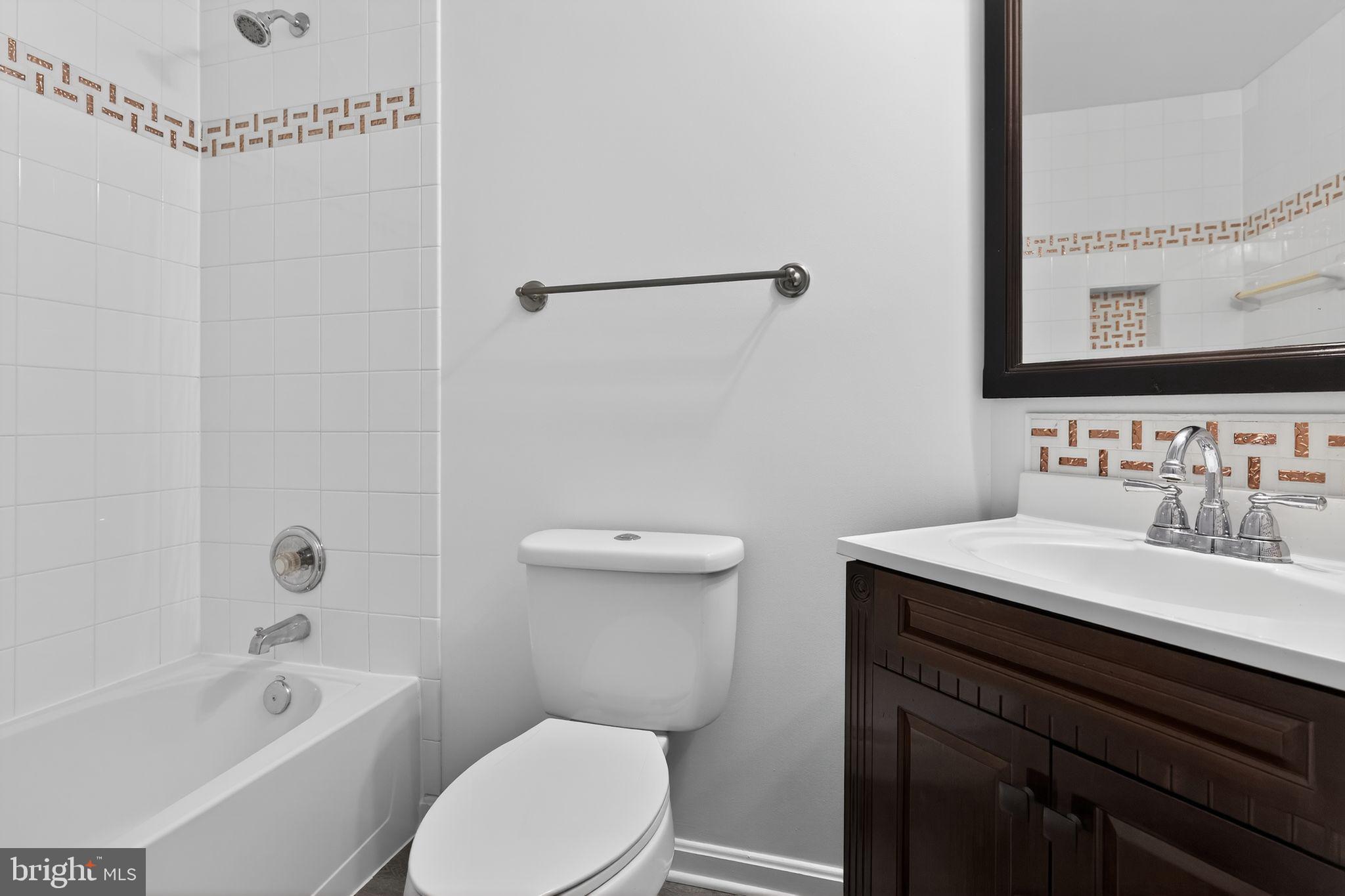 9745 Quiet Brook Lane Clinton, MD 20735 - Photo 36 of 43 a bathroom with a sink a toilet and shower