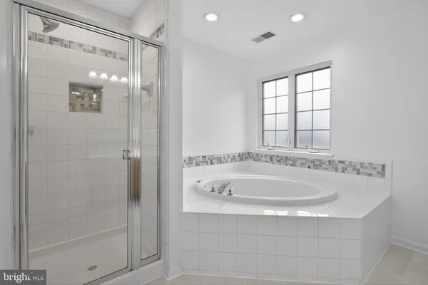 a bathroom with a tub and shower