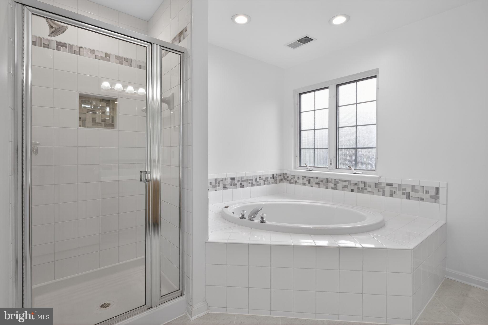 9745 Quiet Brook Lane Clinton, MD 20735 - Photo 37 of 43 a bathroom with a tub and shower