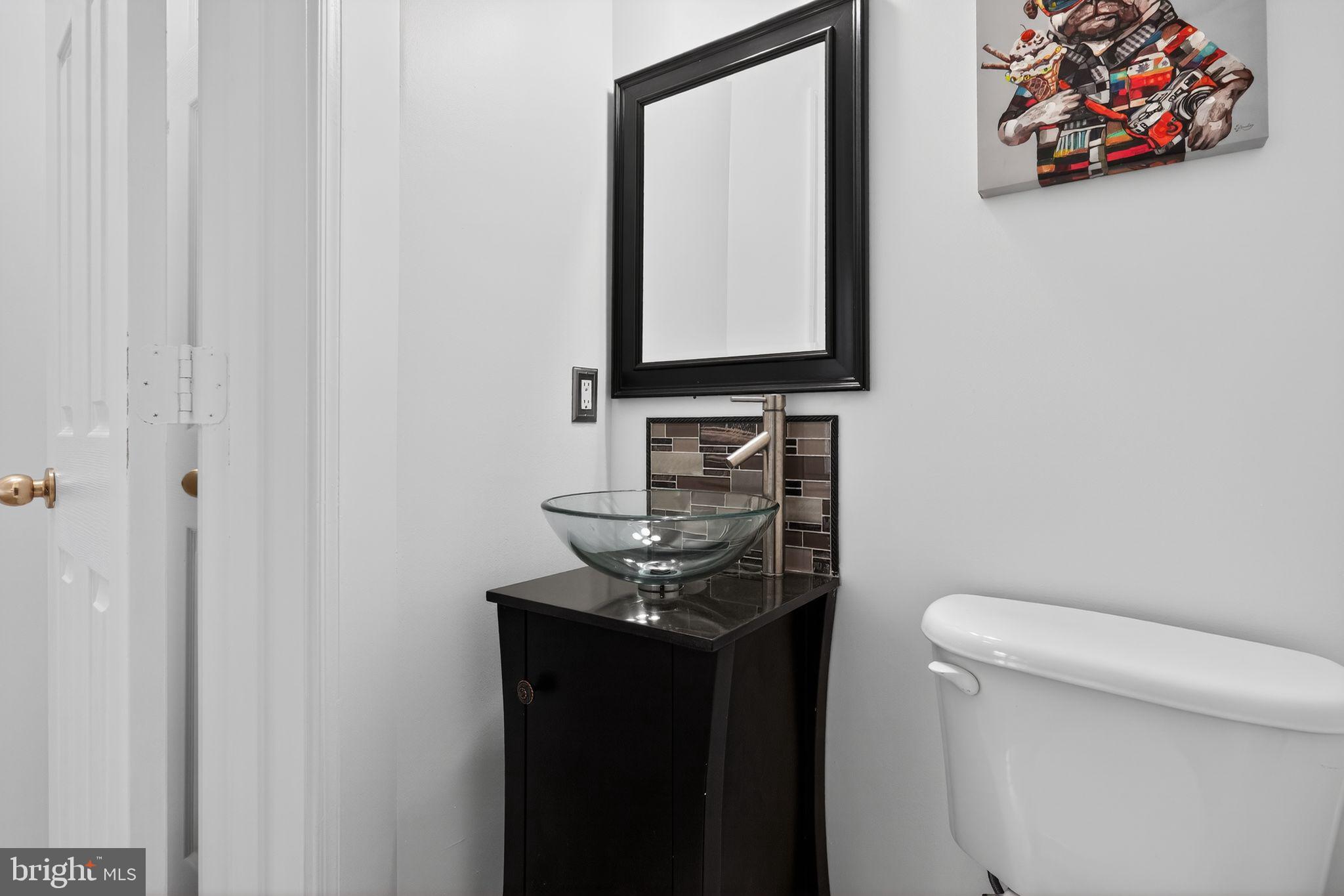 9745 Quiet Brook Lane Clinton, MD 20735 - Photo 38 of 43 a bathroom with a toilet sink and mirror