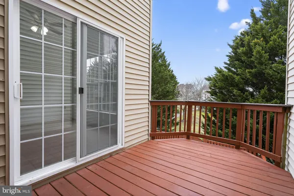 a view of balcony with wooden floor and fence
