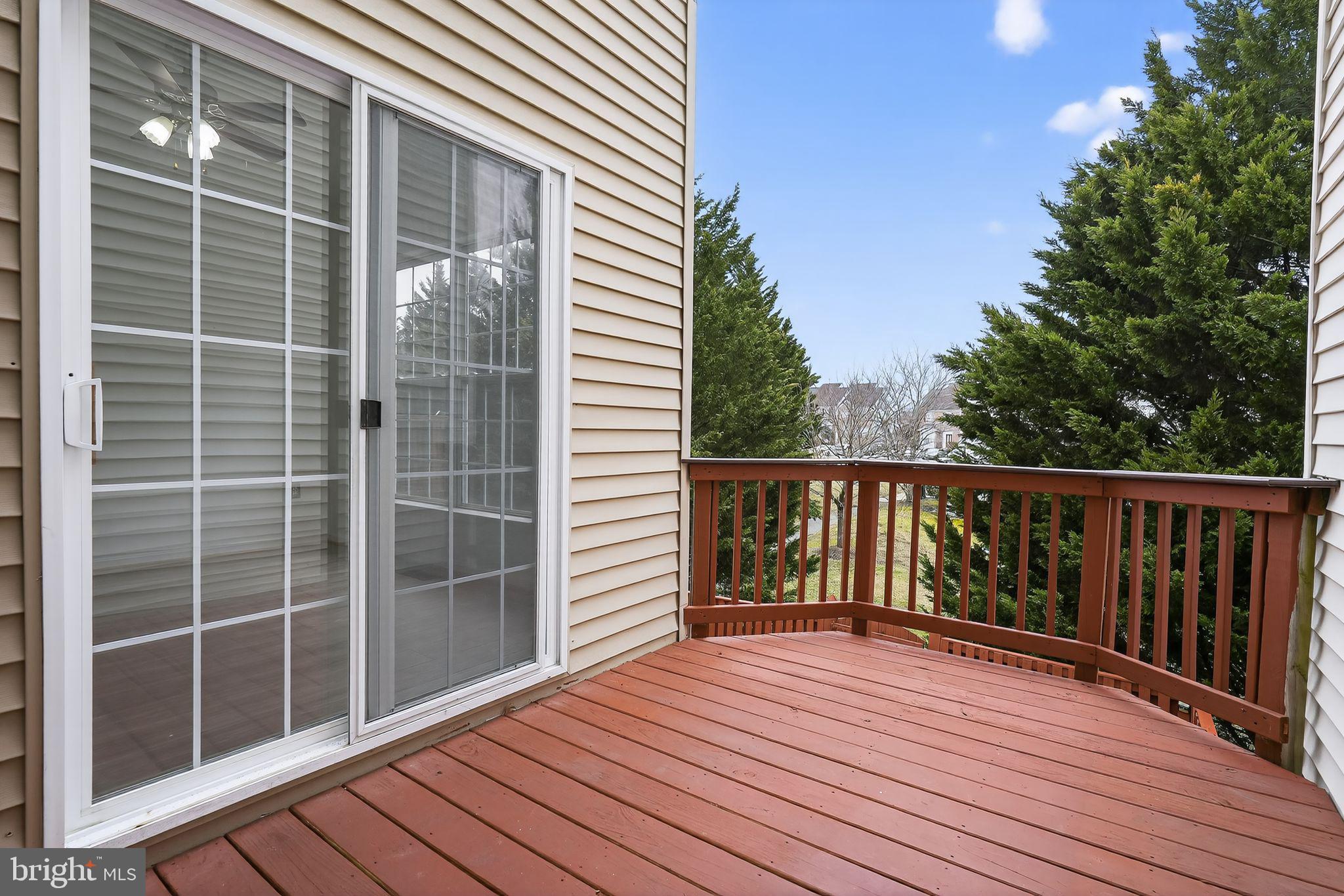 9745 Quiet Brook Lane Clinton, MD 20735 - Photo 41 of 43 a view of balcony with wooden floor and fence