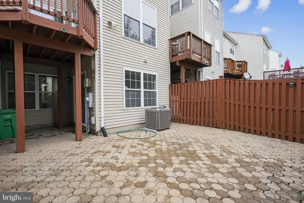 a view of a house with a wooden fence
