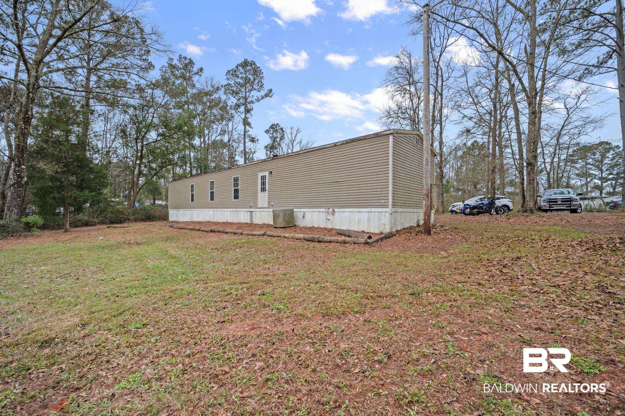 39908 T A Chastang Road Bay Minette, AL 36507 - Photo 19 of 20 View of side of home featuring a yard