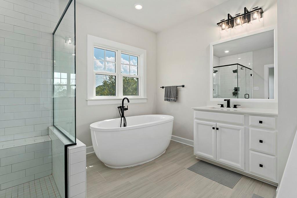 105 Abigail Drive Mars, PA 16046 - Photo 33 of 50 a spacious bathroom with a double vanity sink a mirror and a bathtub