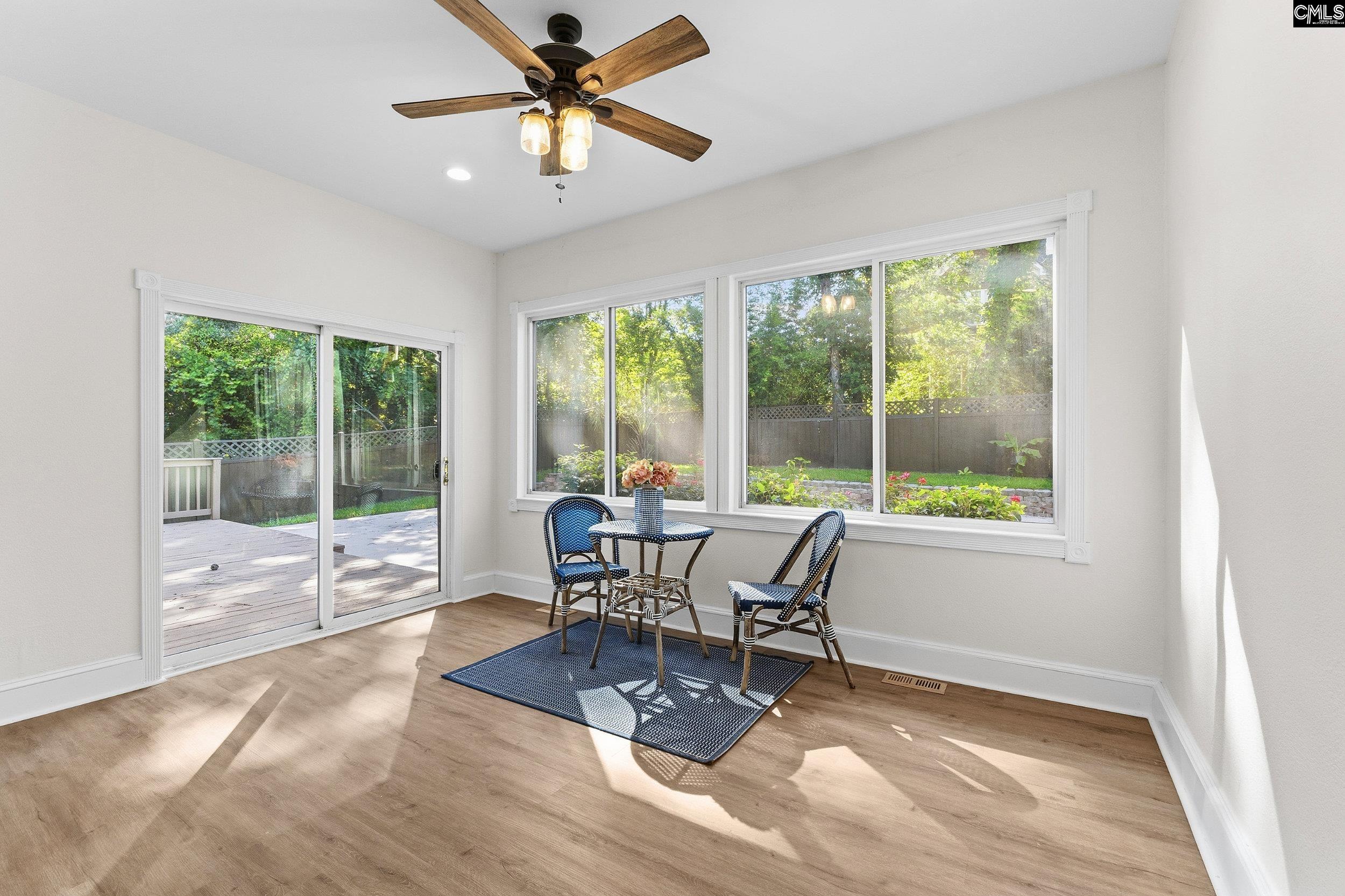 121 Silver Lake Road East Columbia, SC 29223 - Photo 21 of 57 a dining room with wooden floor and a floor to ceiling window
