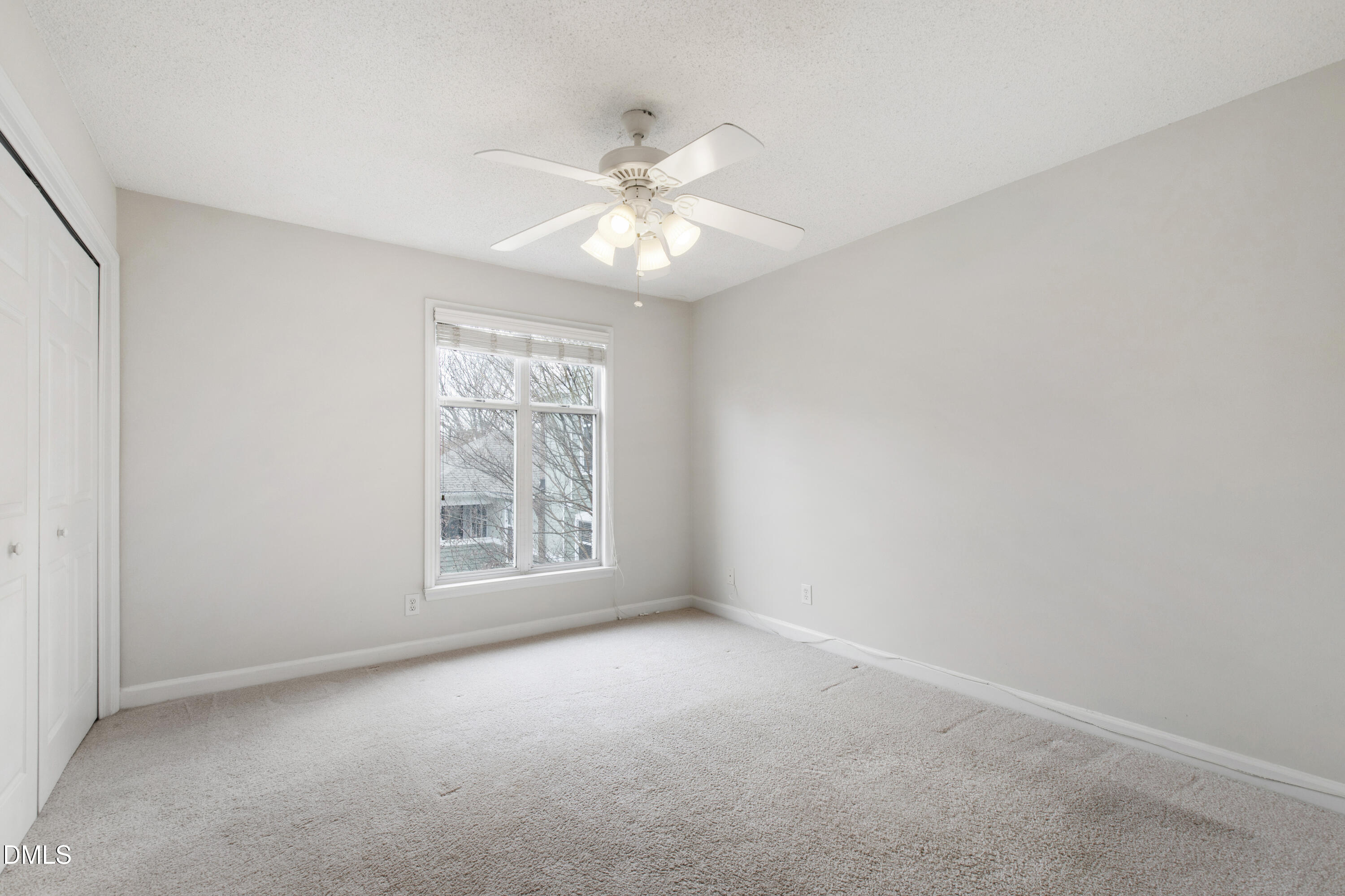 1210 Westview Lane, Unit 303 Raleigh, NC 27605 - Photo 14 of 27 an empty room with windows and fan