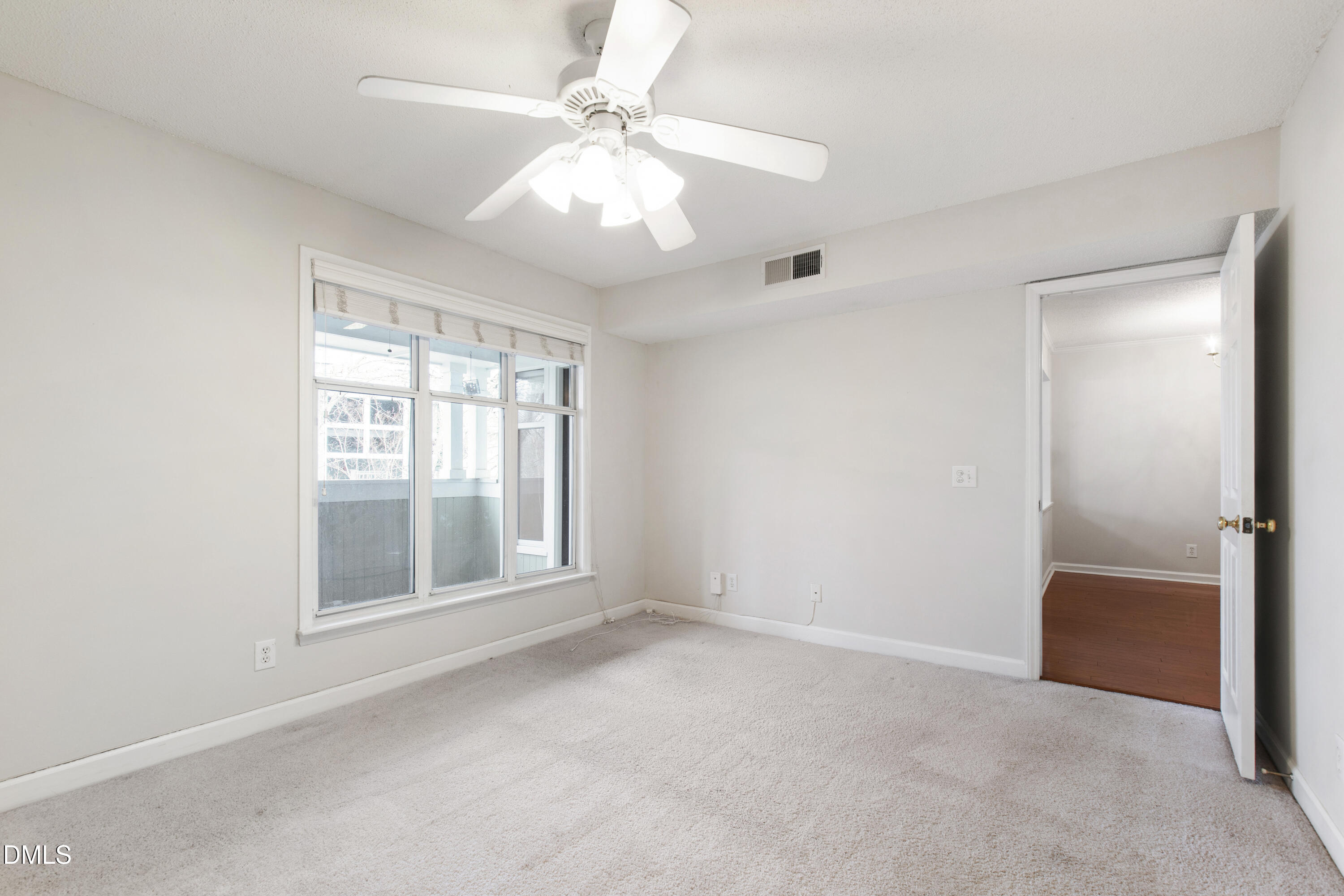 1210 Westview Lane, Unit 303 Raleigh, NC 27605 - Photo 15 of 27 an empty room with chandelier fan and windows