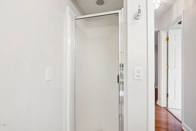 a bathroom with a glass shower door