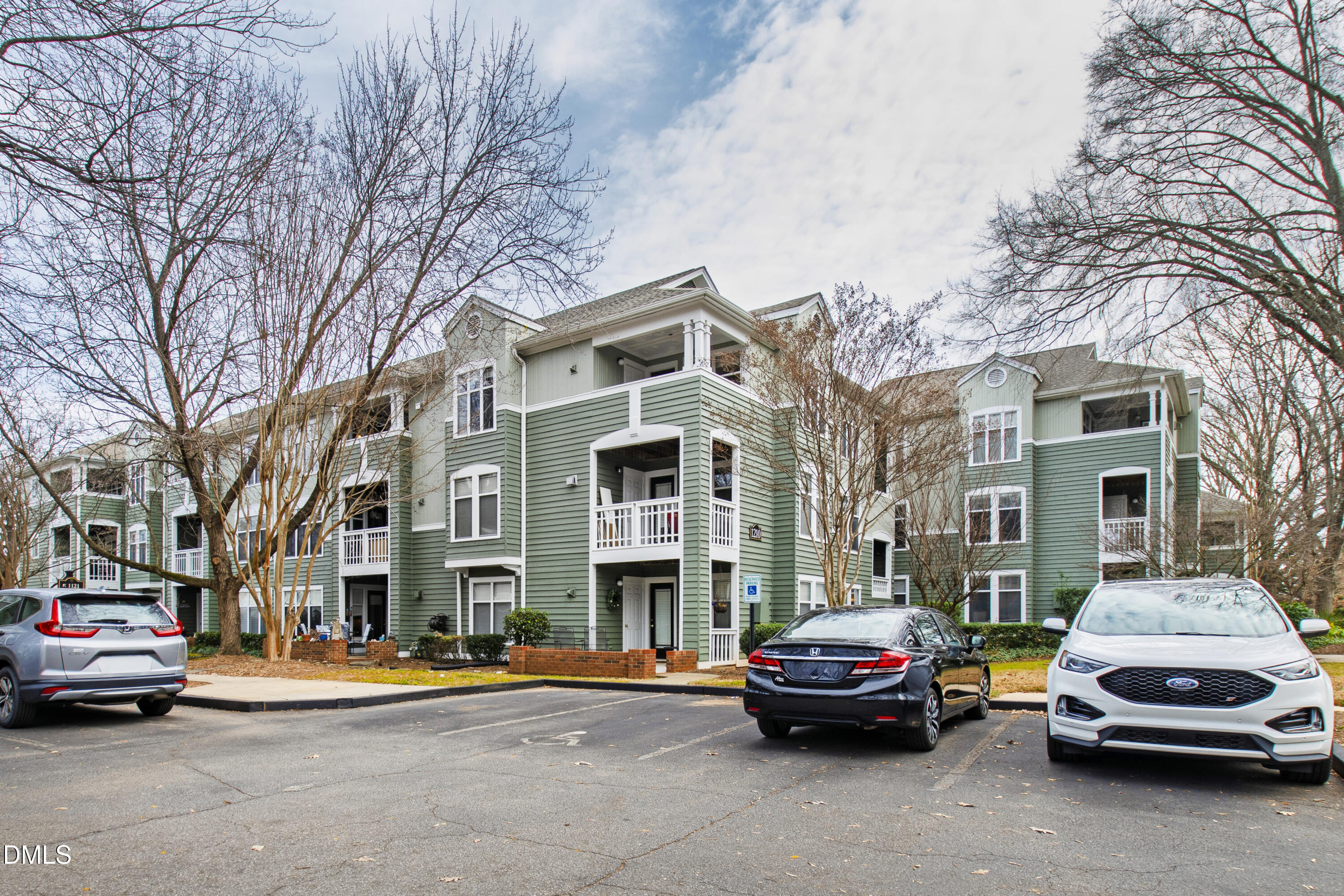1210 Westview Lane, Unit 303 Raleigh, NC 27605 - Photo 26 of 27 a car parked in front of a brick building