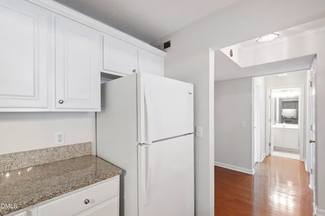 a white refrigerator freezer sitting inside of a kitchen