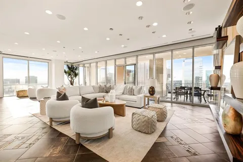 a living room with furniture and large windows