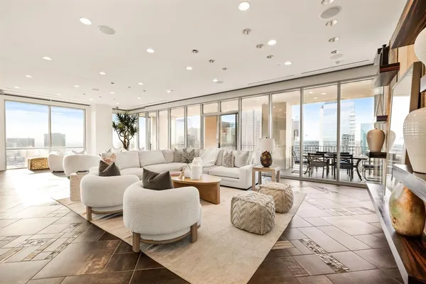 a living room with furniture and large windows