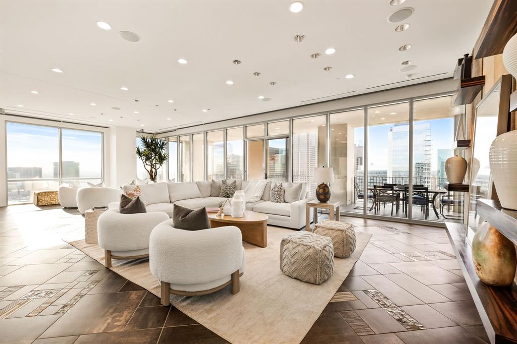 a living room with furniture and large windows