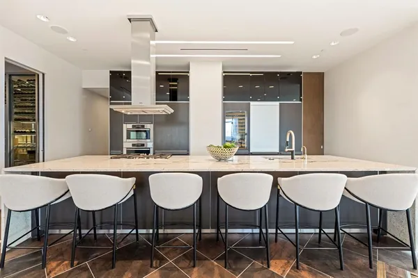 a dining table with chairs and view kitchen island