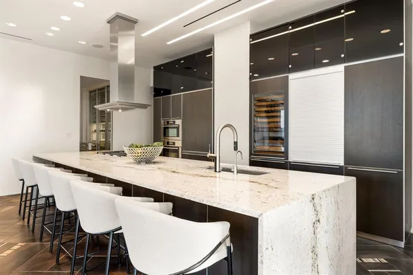 a kitchen with stainless steel appliances kitchen island granite countertop a sink and cabinets