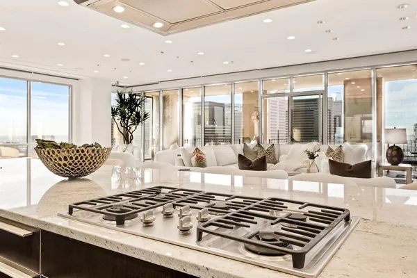 a large white kitchen with a large window