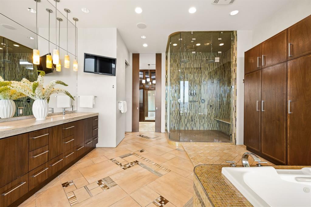 1717 Arts Plaza, Unit 2002 Dallas, TX 75201 - Photo 26 of 36 a spacious bathroom with a mirror sink and shower