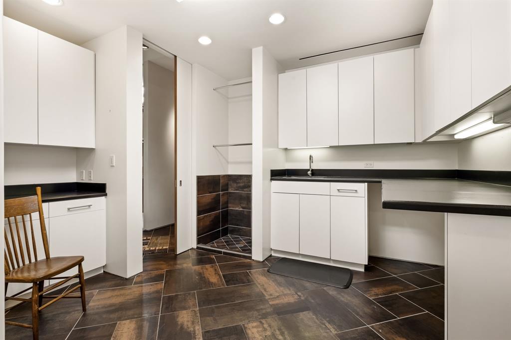 1717 Arts Plaza, Unit 2002 Dallas, TX 75201 - Photo 28 of 36 a kitchen with a sink and cabinets