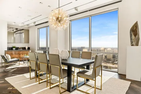 a view of a dining room with furniture and chandelier