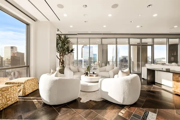 a living room with furniture and floor to ceiling window