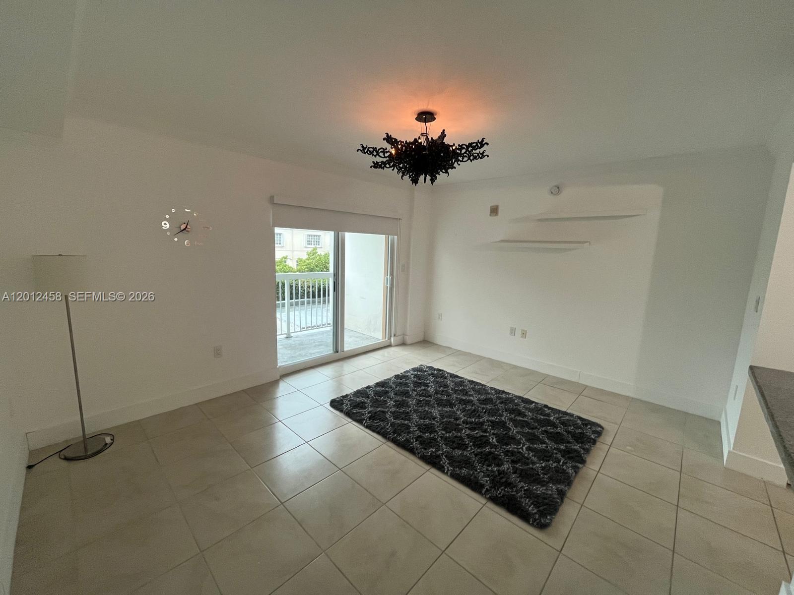 2740 Southwest 28th Terrace, Unit 203 Miami, FL 33133 - Photo 12 of 14 a view of a room with wooden floor and a carpet
