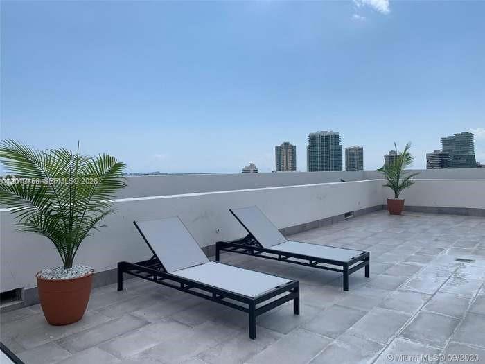 2740 Southwest 28th Terrace, Unit 203 Miami, FL 33133 - Photo 3 of 14 a living room with a potted plant and outdoor seating