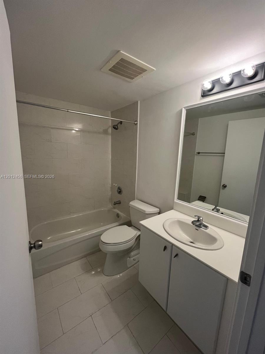 2740 Southwest 28th Terrace, Unit 203 Miami, FL 33133 - Photo 6 of 14 a bathroom with a sink a toilet and shower