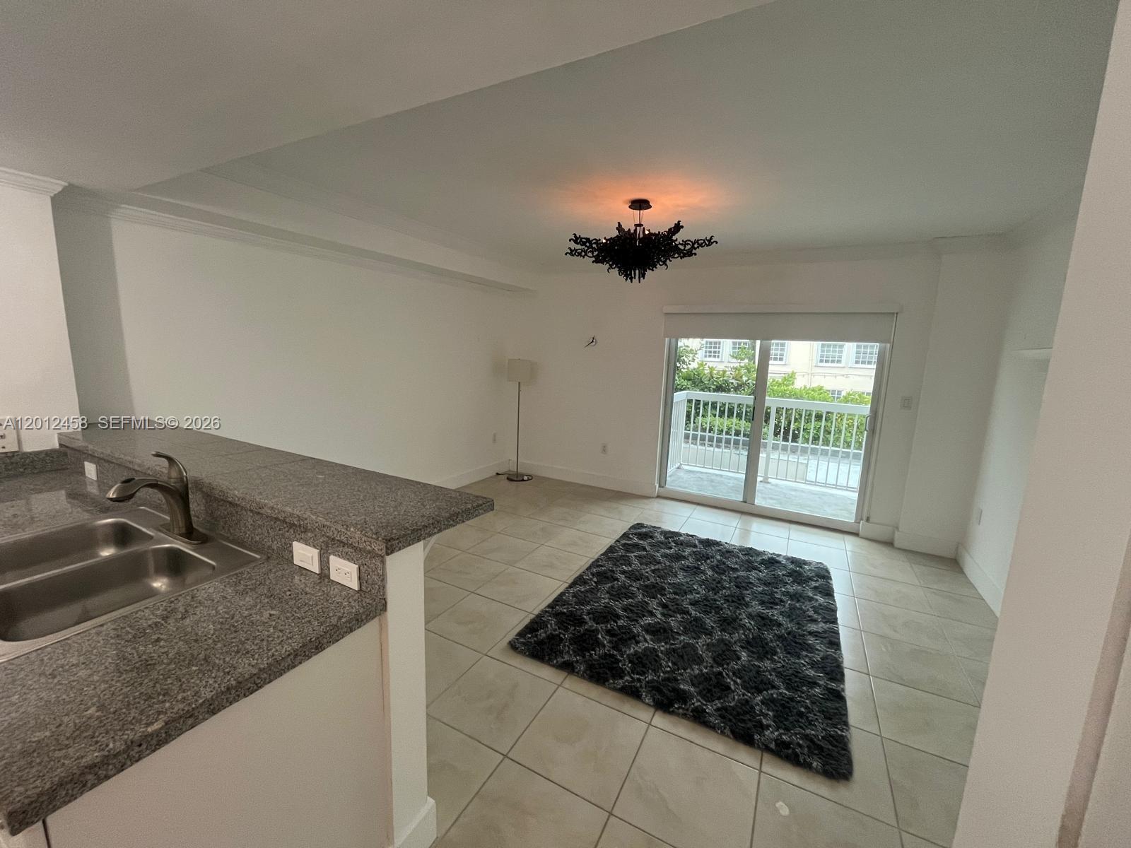 2740 Southwest 28th Terrace, Unit 203 Miami, FL 33133 - Photo 9 of 14 a bathroom with a granite countertop sink a toilet and a window