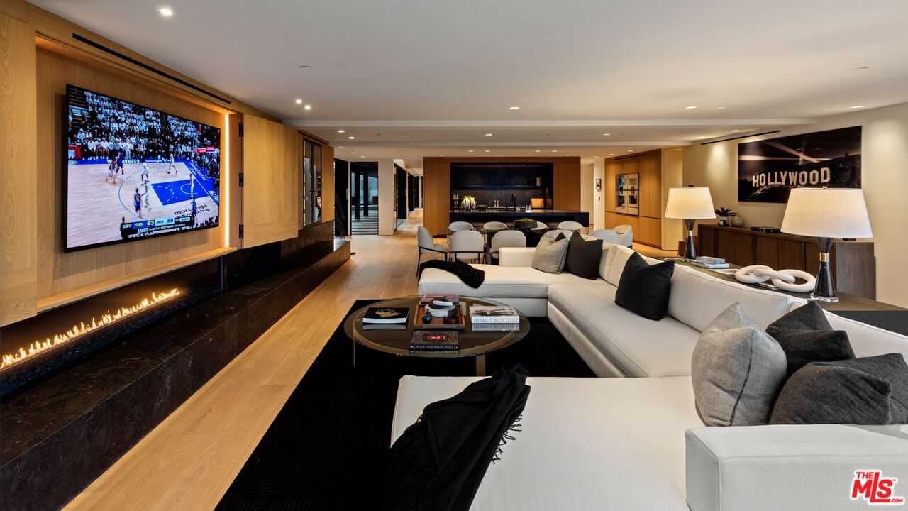 1663 Summitridge Drive Beverly Hills, CA 90210 - Photo 11 of 41 a living room with furniture and a flat screen tv