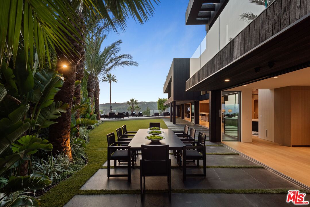 1663 Summitridge Drive Beverly Hills, CA 90210 - Photo 14 of 41 a view of a chairs and table in patio with a barbeque grill