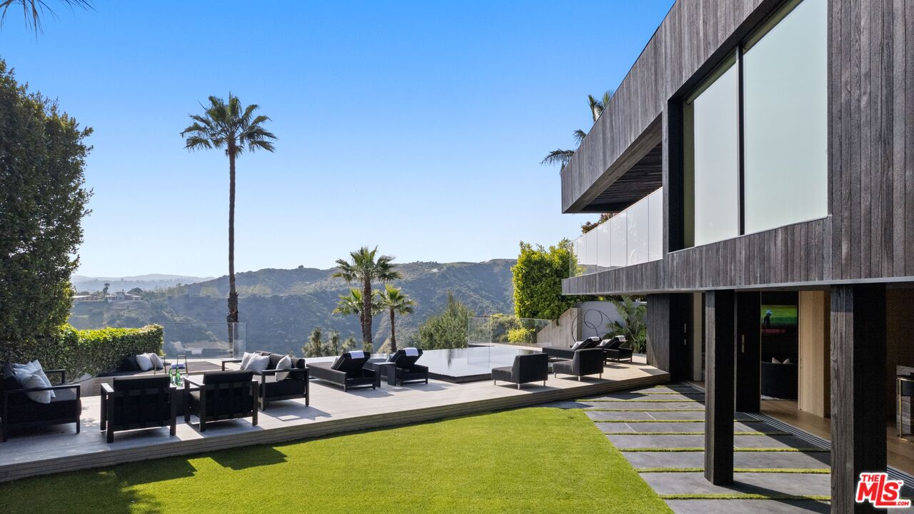 1663 Summitridge Drive Beverly Hills, CA 90210 - Photo 15 of 41 a view of a swimming pool with chairs
