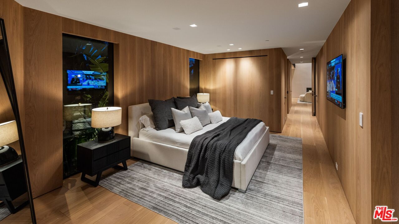 1663 Summitridge Drive Beverly Hills, CA 90210 - Photo 30 of 41 a bedroom with a bed and a mirror