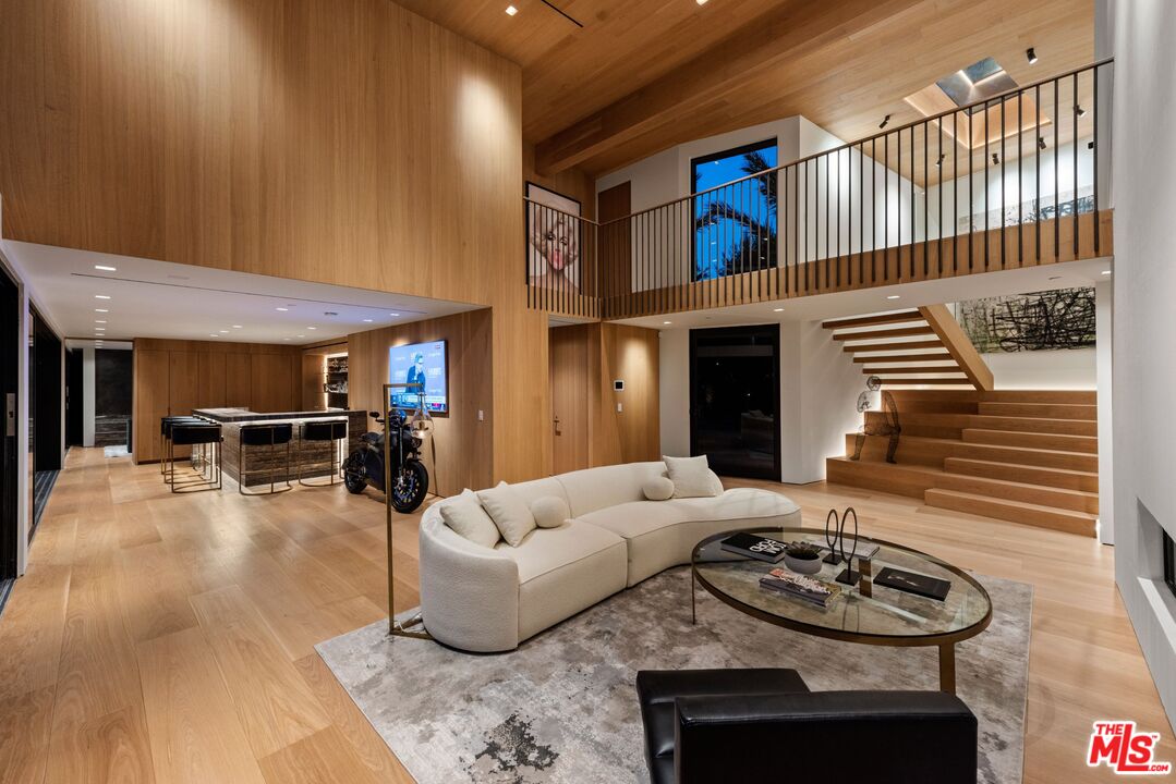 1663 Summitridge Drive Beverly Hills, CA 90210 - Photo 3 of 41 a living room with furniture and a fireplace