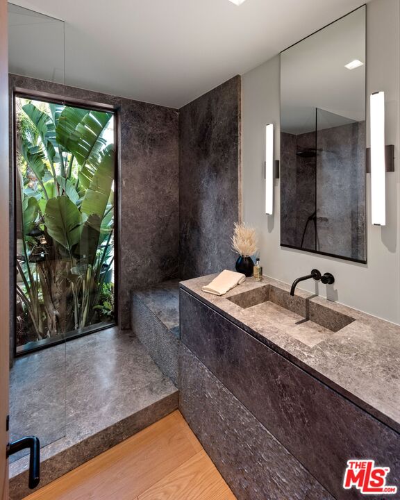 1663 Summitridge Drive Beverly Hills, CA 90210 - Photo 34 of 41 a bathroom with a granite countertop sink and a mirror